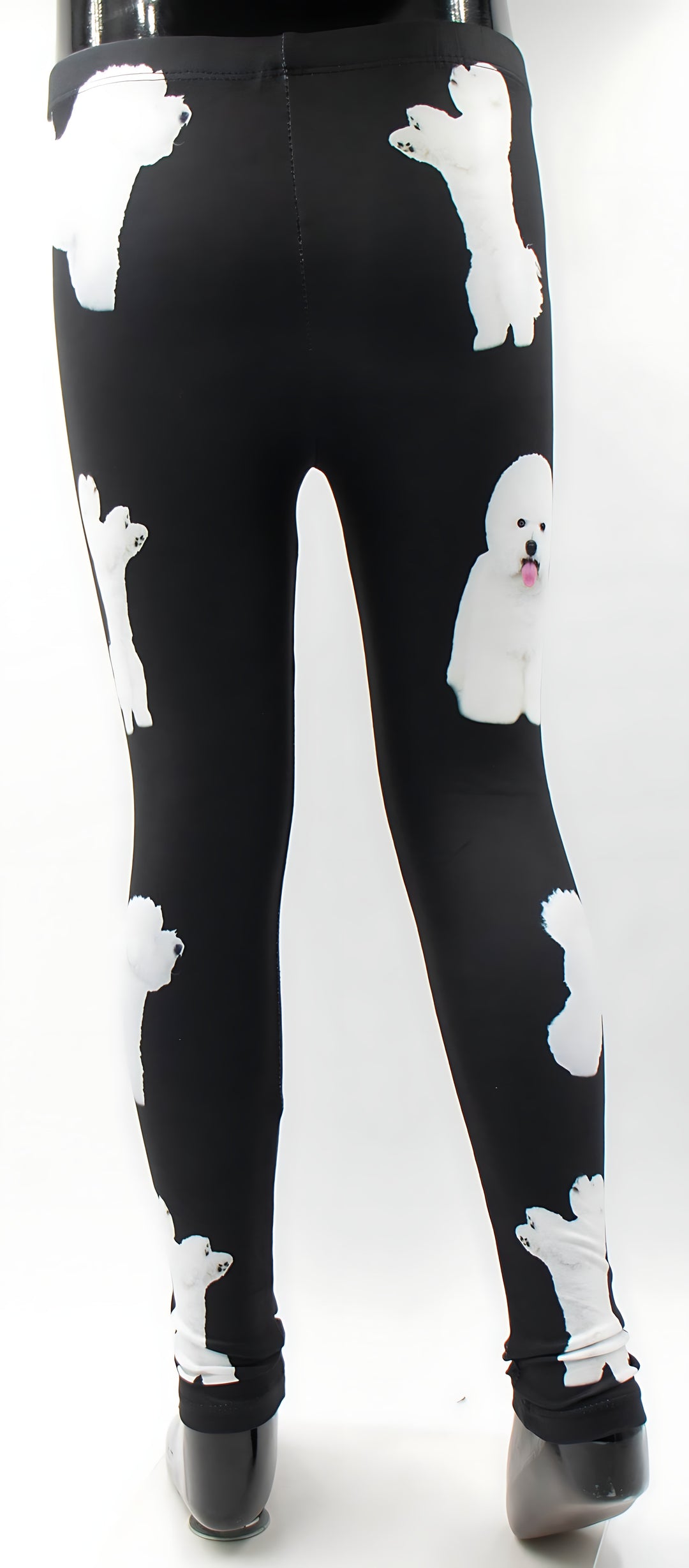 Back view of kids Bichon print leggings with white Bichon Frise dog prints on black, shown on a child mannequin.