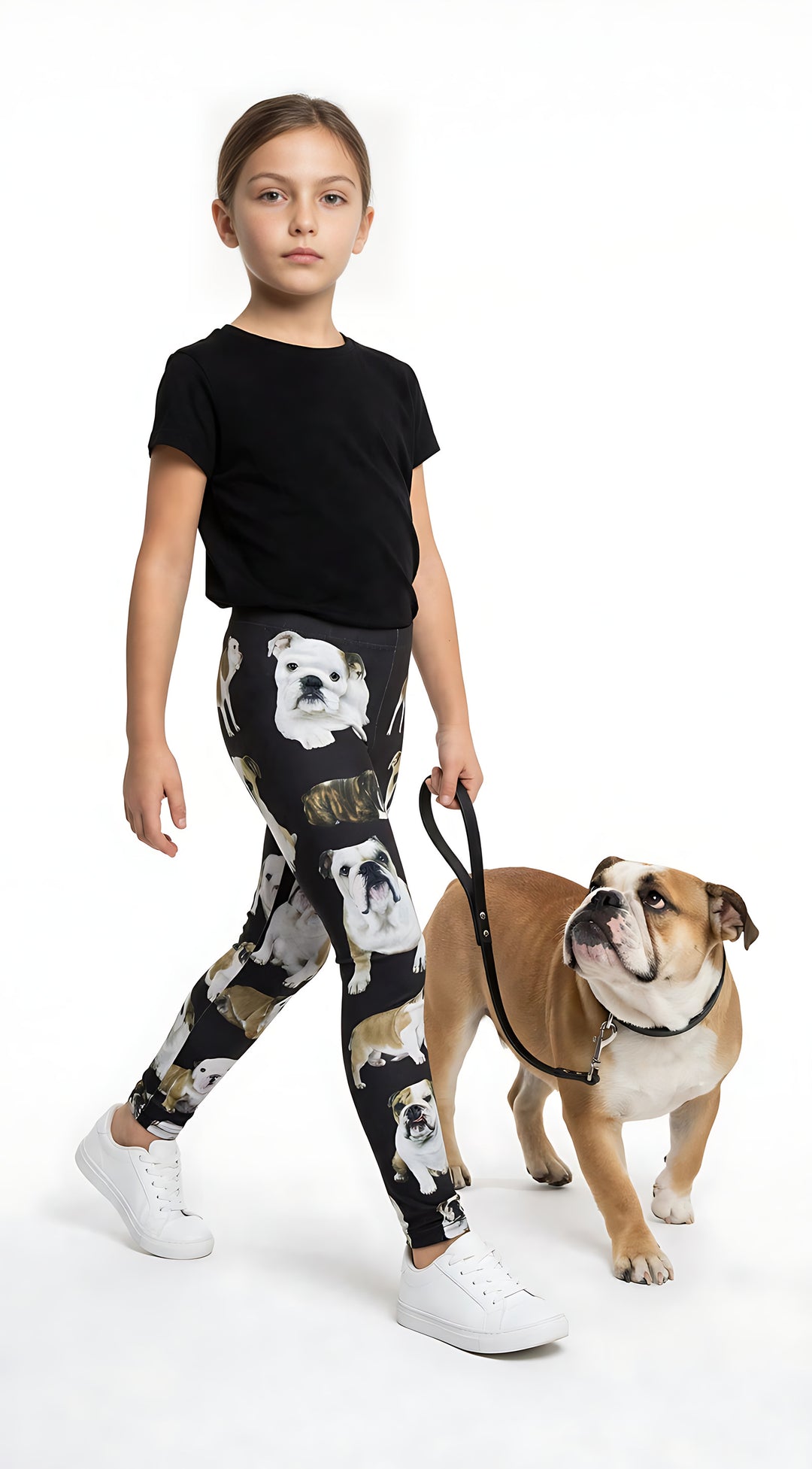 Young girl walking a real English Bulldog on a leash, wearing kids English Bulldog print leggings with bulldog prints, black tee, white sneakers.