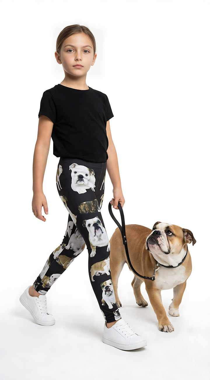 Young girl walking a real English Bulldog on a leash, wearing kids English Bulldog print leggings with bulldog prints, black tee, white sneakers.