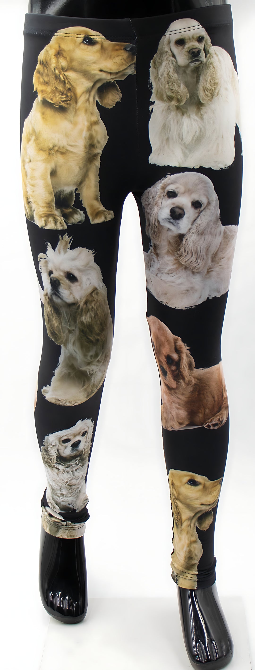 Close-up of kids Cocker Spaniel print leggings on a mannequin, golden and cream spaniel portraits on black fabric.