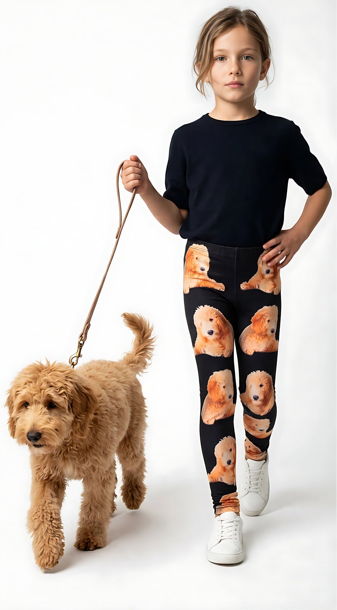 Young girl walking a real Goldendoodle on a leash, wearing kids Goldendoodle print leggings and a black t-shirt.