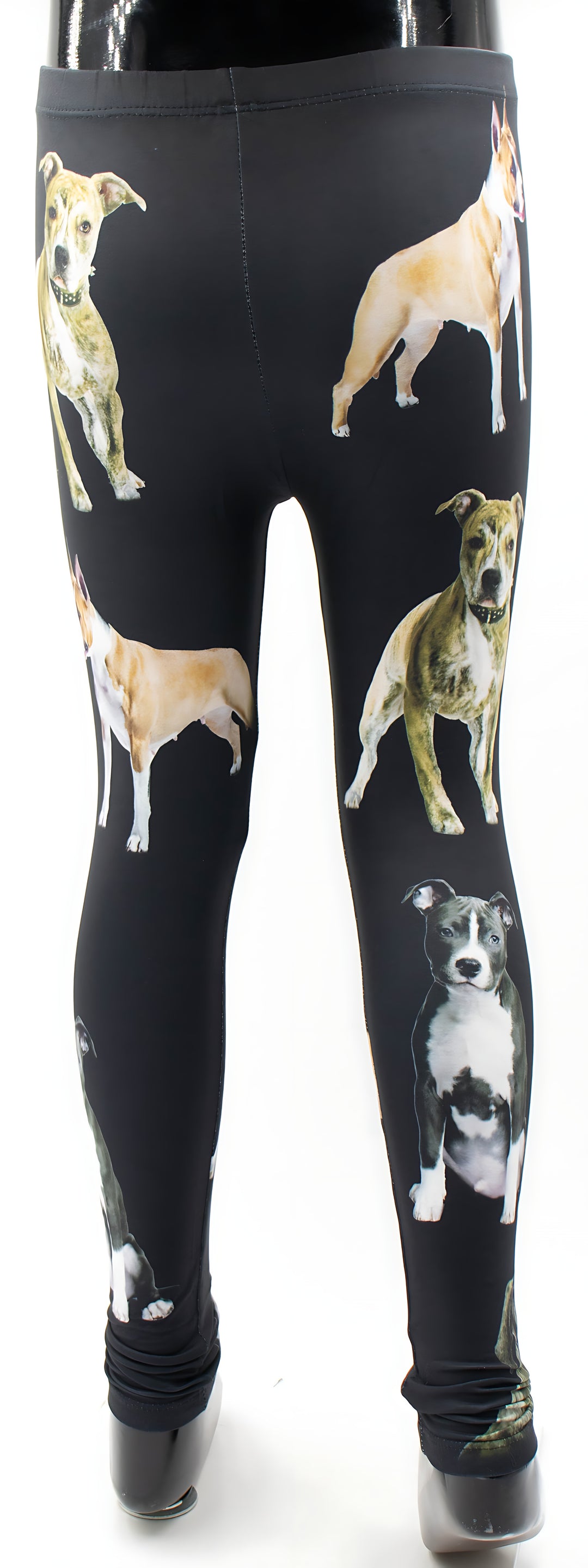 Kids Pit Bull print leggings with standing tan and brindle pit bull portraits on black fabric, full-length mannequin product shot.