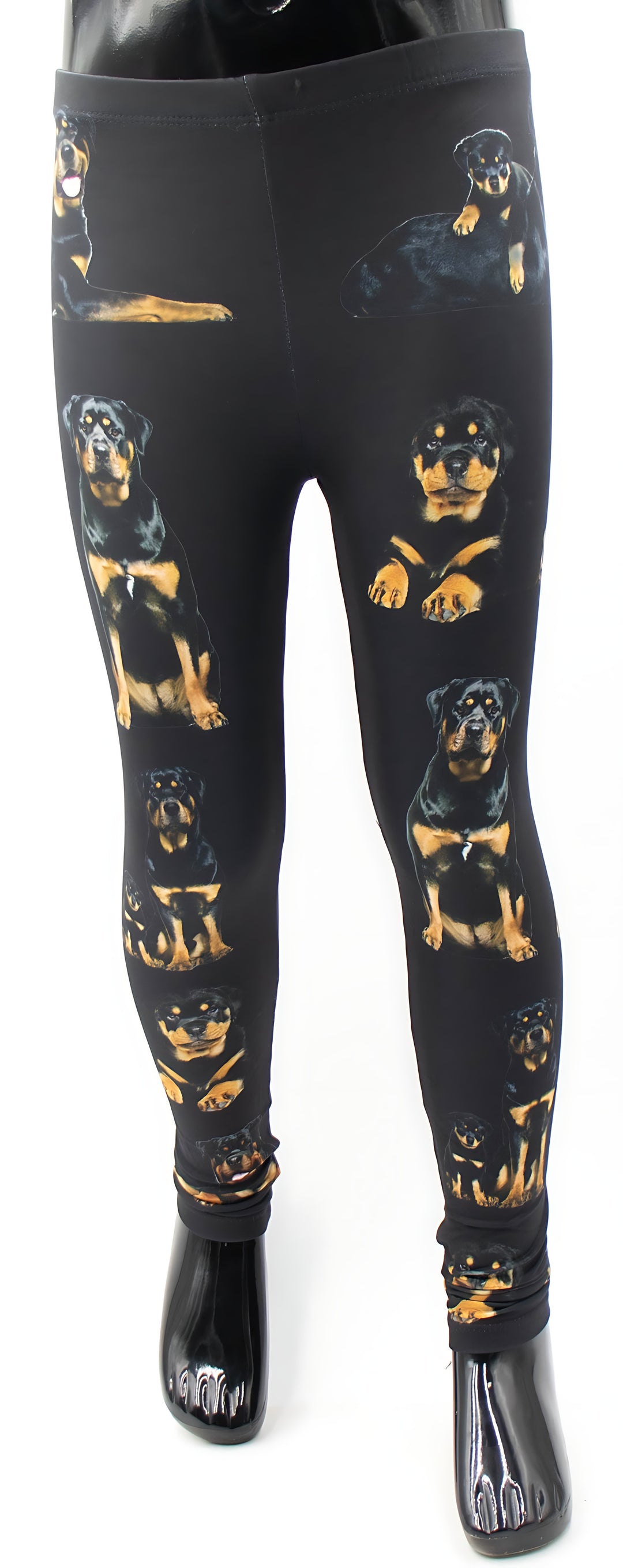 Kids Rottweiler print leggings with realistic black and tan rottweiler portraits on black fabric, front view on a mannequin.
