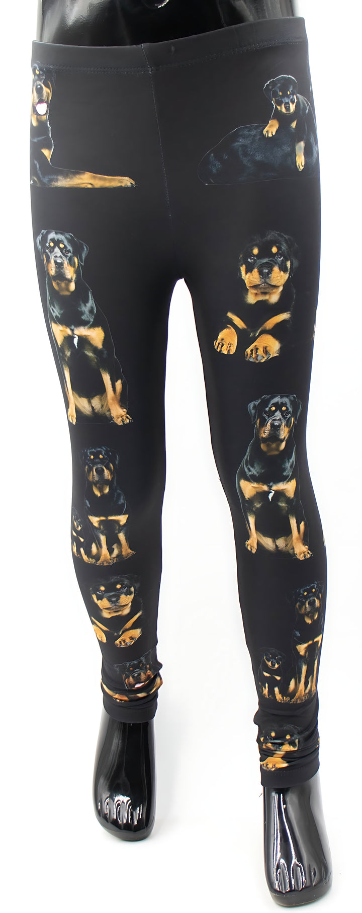 Kids Rottweiler print leggings with realistic black and tan rottweiler portraits on black fabric, front view on a mannequin.