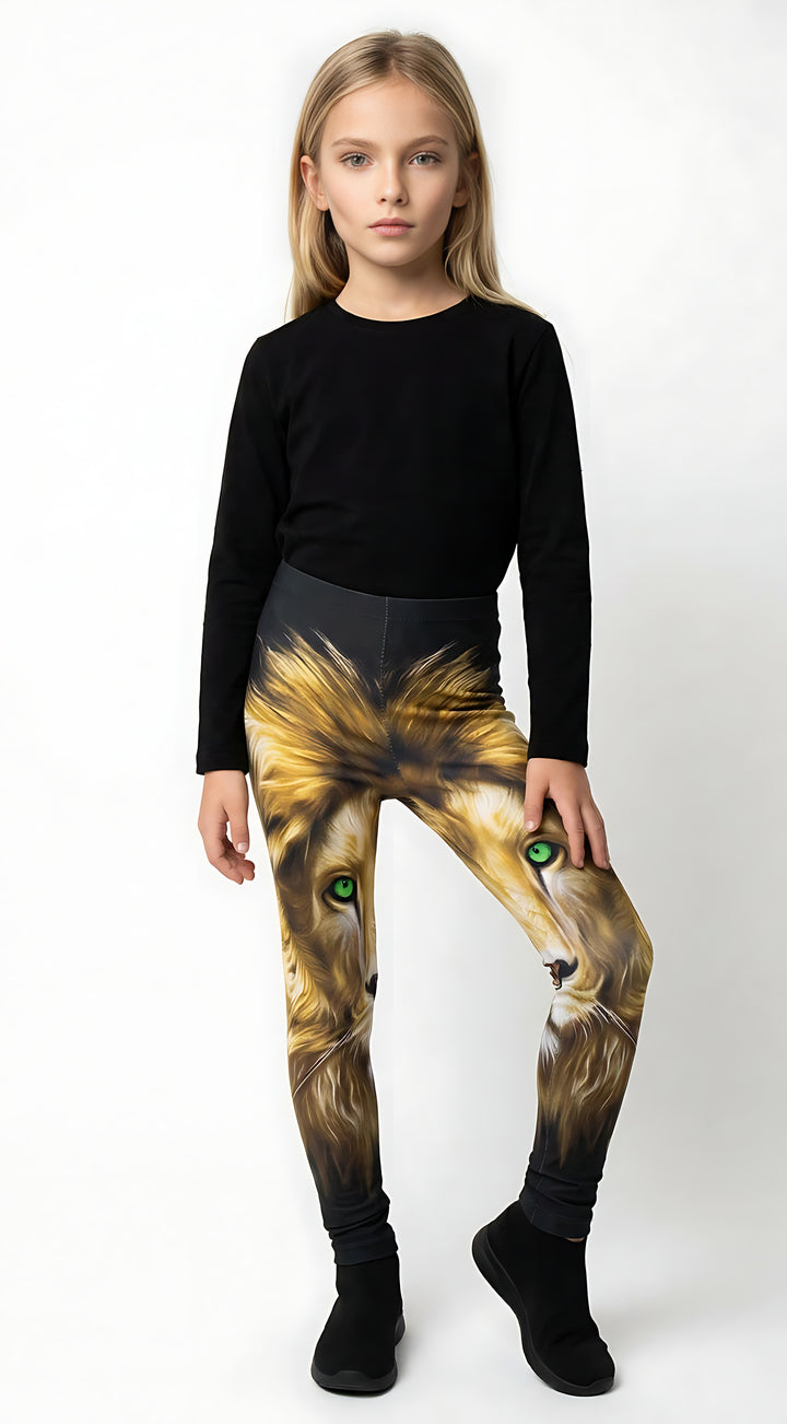 Young girl wearing kids lion print leggings with a golden lion face and green eyes, black top and shoes.
