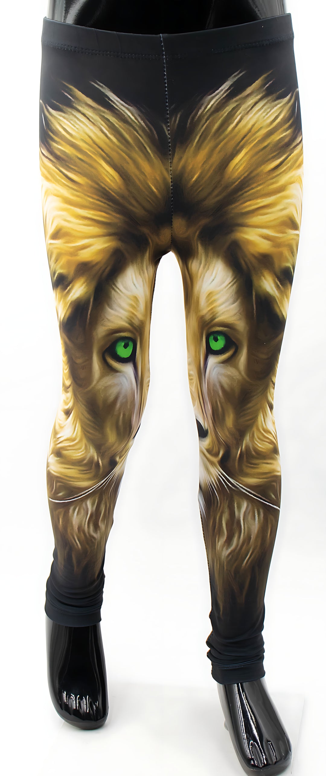 Close-up of kids lion print leggings on a mannequin, golden lion face with green eyes on black fabric.