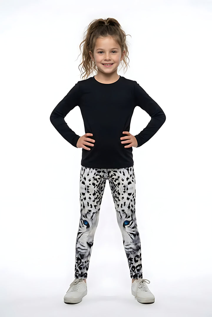 Girl wearing white snow leopard print kids leggings
