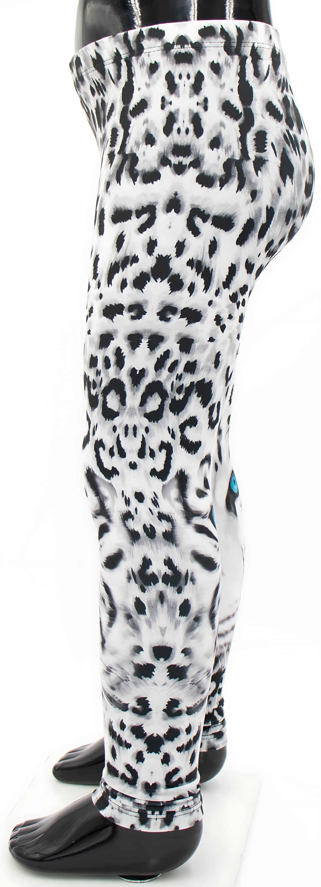 Side view of kids snow leopard print leggings on a mannequin, spotted white fur with a blue eye visible on the calf.