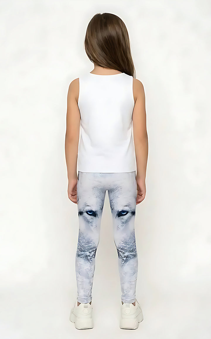Back view of a girl in a white tank top wearing white and gray wolf print girls leggings with blue eyes