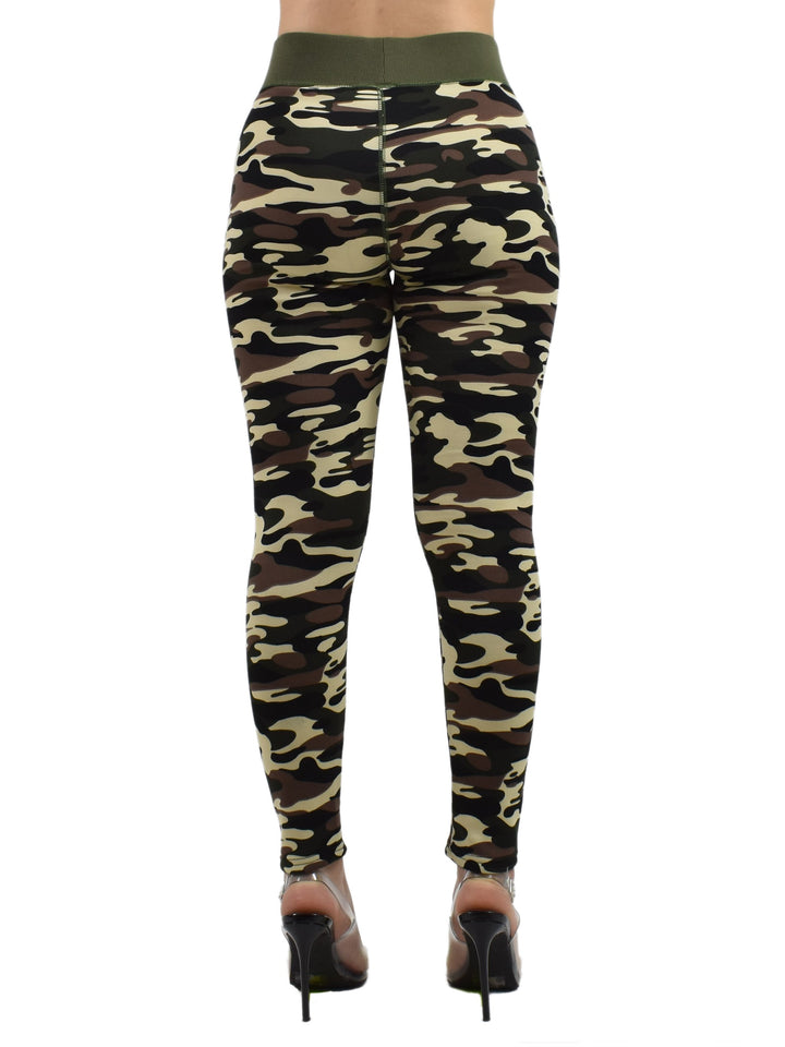 Back view of the Denimaxx Woodland Camo winter leggings in green and brown camo with an olive waistband, modeled with heels on a white background.