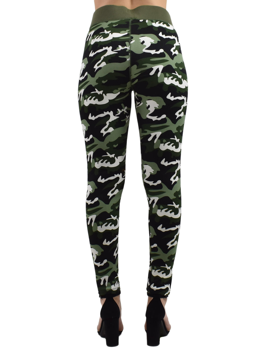 Back view of Denimaxx Northern Woods camo leggings in green, black, and white woodland print, modeled with black heeled sandals.