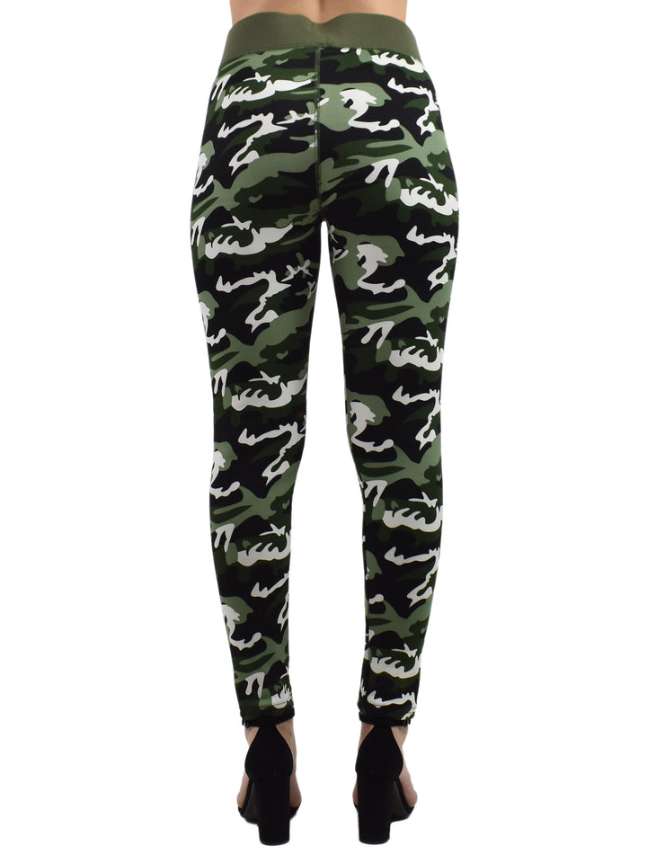 Back view of Denimaxx Northern Woods camo leggings in green, black, and white woodland print, modeled with black heeled sandals.