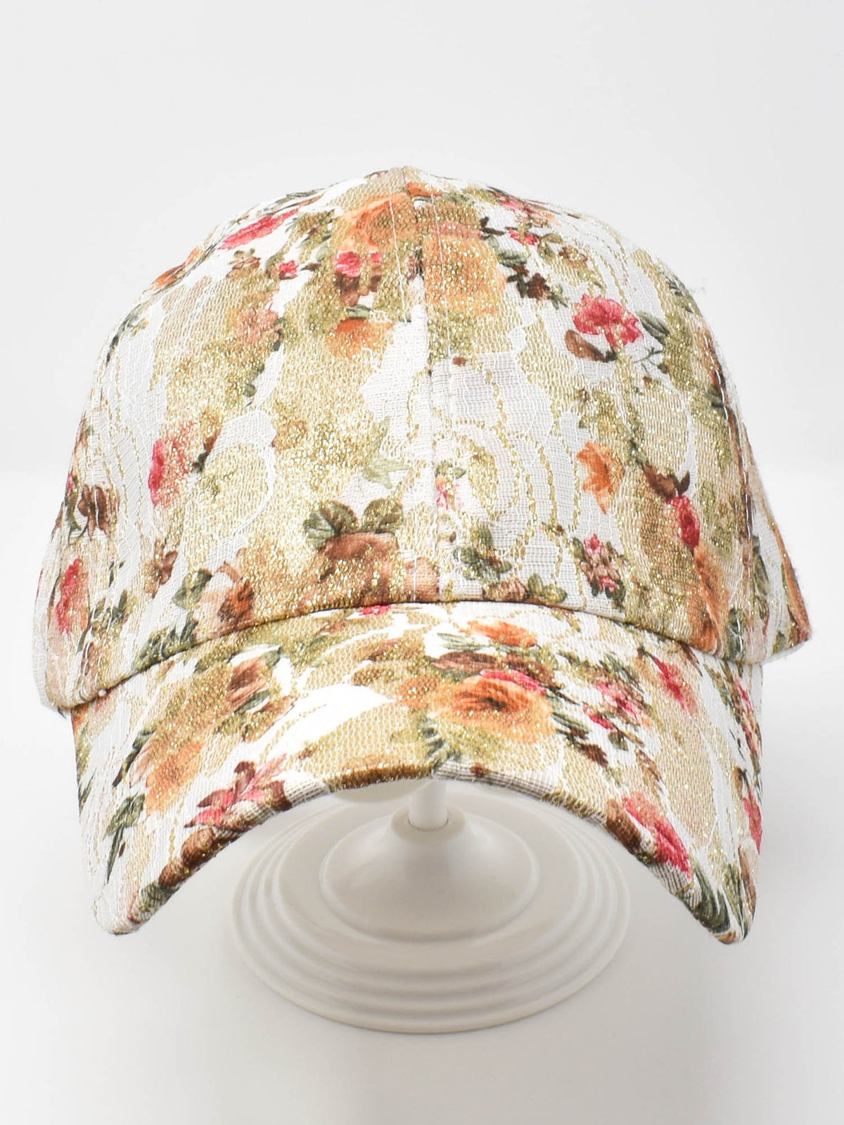 Rose Garden floral print baseball cap with red and orange roses on cream fabric, studio shot on white.