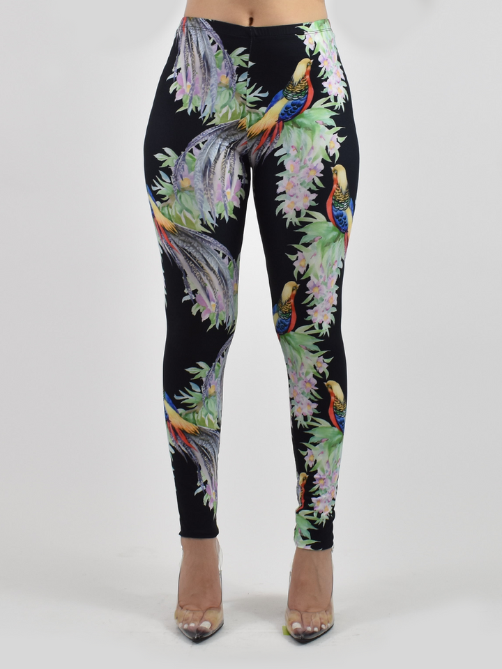 Front view of Denimaxx tropical bird print leggings showing vivid pheasant and blossom artwork on black, modeled in a studio.