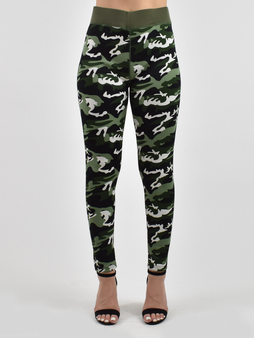 Woman wearing Denimaxx lined camo leggings with green and white camouflage print and olive waistband, black strappy sandals.
