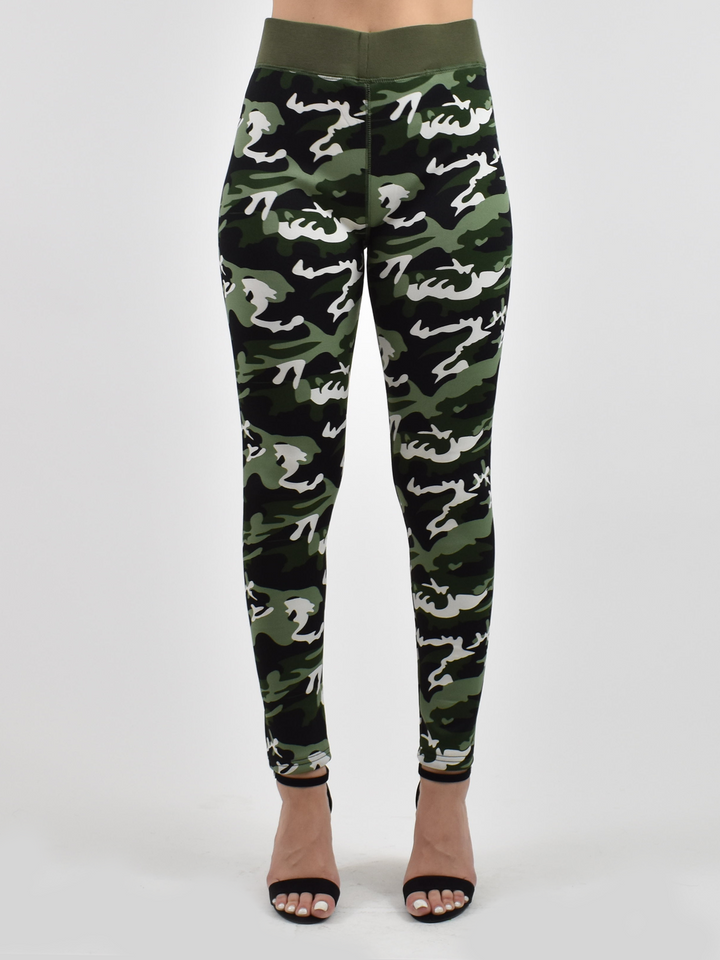 Woman wearing Denimaxx lined camo leggings with green and white camouflage print and olive waistband, black strappy sandals.
