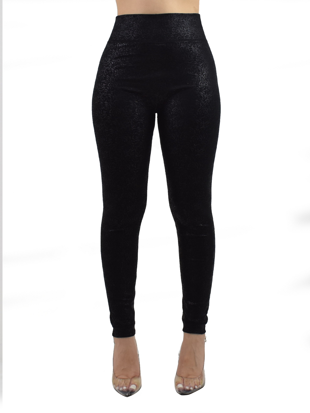 Woman wearing Denimaxx black lined leggings with a subtle embossed floral texture, clear heels, front studio view.