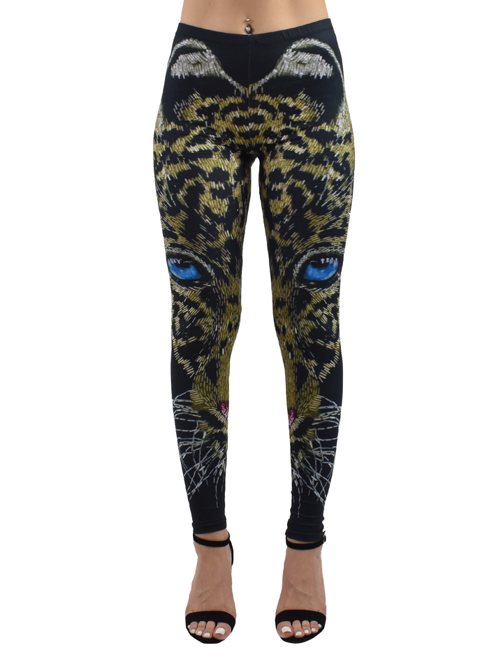 Front view of Denimaxx cheetah mosaic leggings with a blue-eyed cheetah face rendered in mosaic tiles across the legs, modeled in a studio.