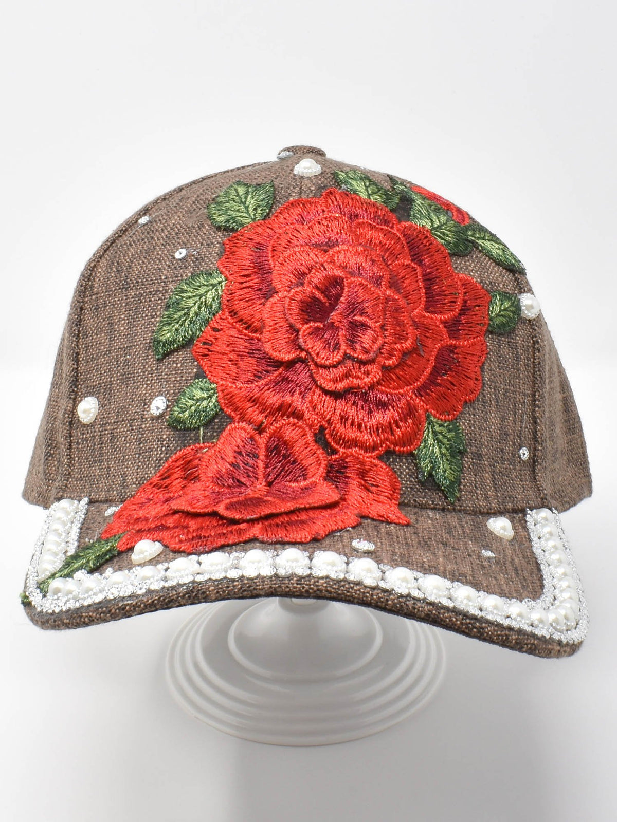 Corrupted multicolor striped image file on the Red Rose Cap product page, no product visible.