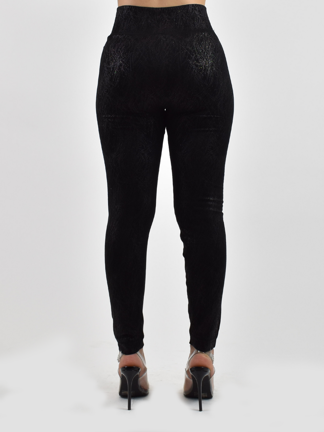 Back view of woman wearing Denimaxx black lined leggings with textured finish, black heels.