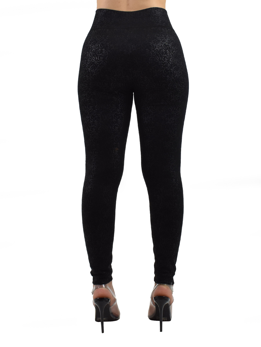 Back view of woman wearing Denimaxx black lined leggings with embossed floral texture, black heels.
