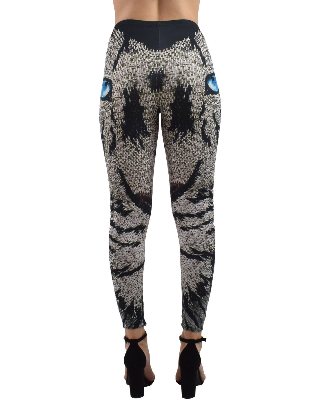 Back view of woman wearing Denimaxx Lion Mosaics print leggings with mosaic lion artwork, black block heels.
