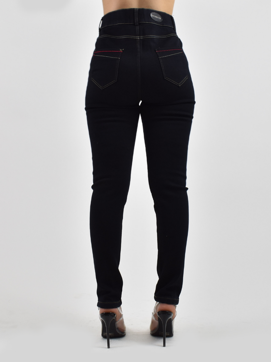 Back view of woman wearing Denimaxx black lined jean leggings showing back pockets with red contrast stitching.