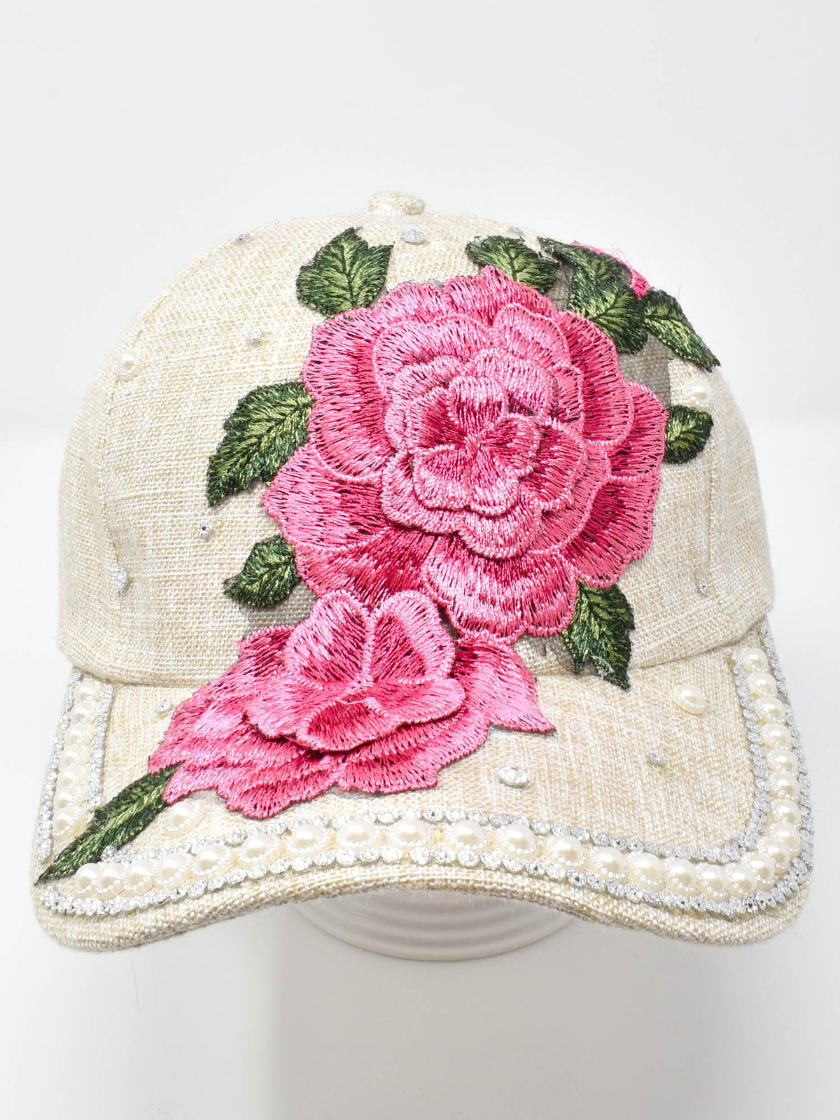 Pink Rose cap with large pink embroidered roses, green leaves, and pearl bead trim on the brim, front view.