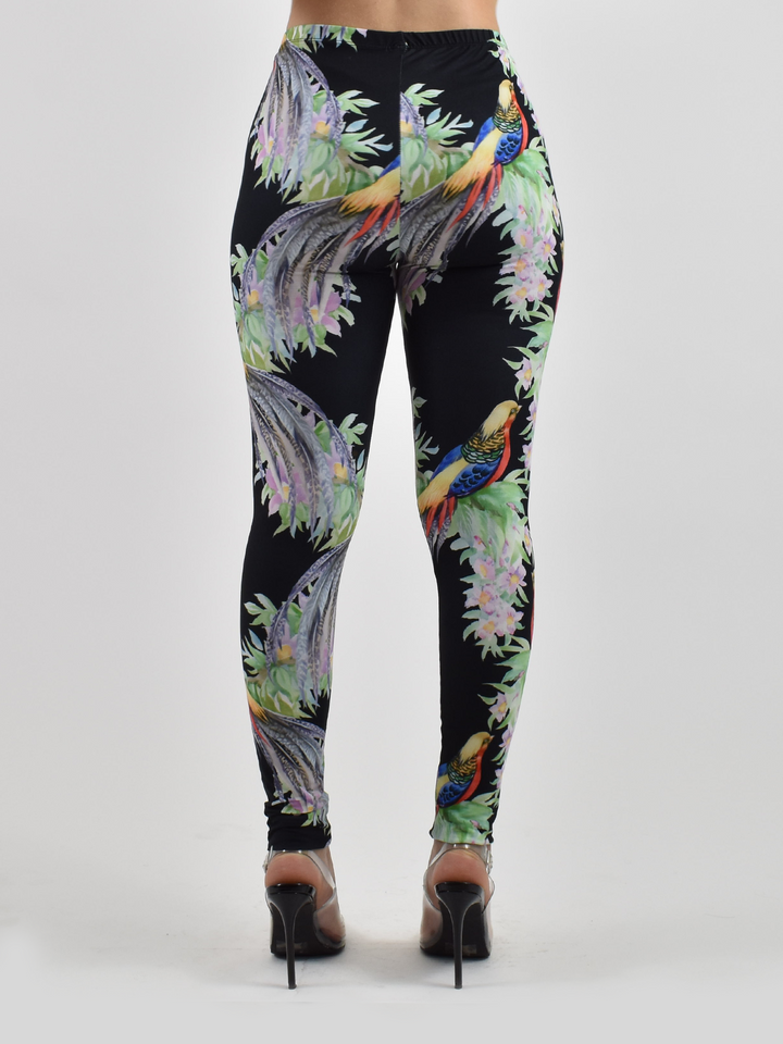 Back view of Denimaxx tropical bird print leggings displaying the colorful bird and floral print, modeled with black heels.