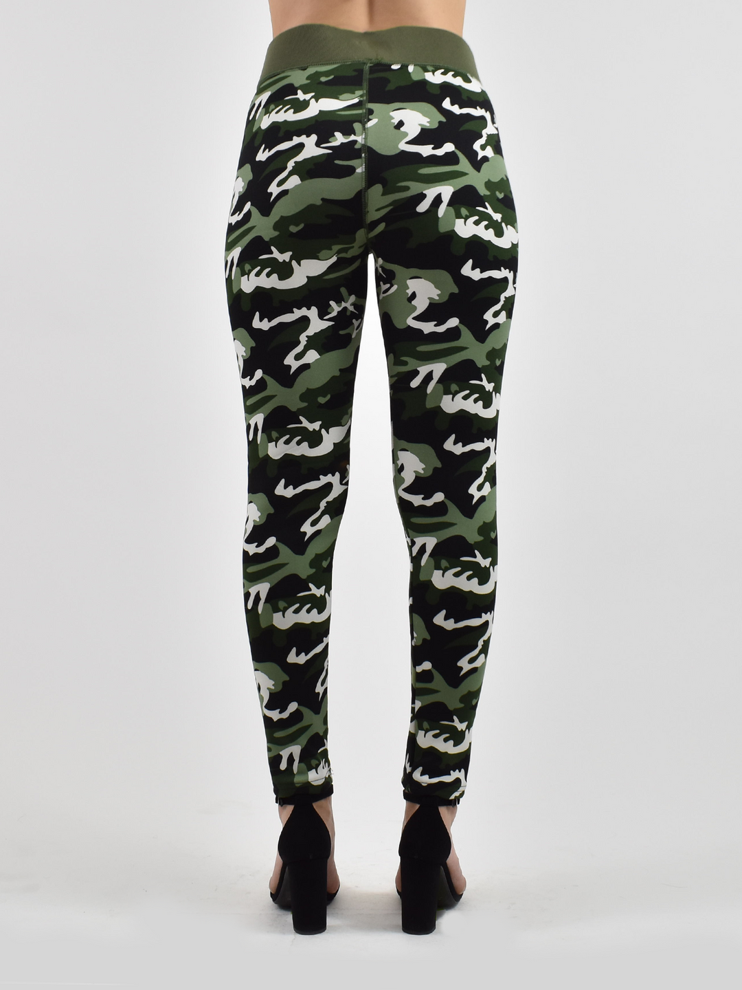 Back view of woman wearing Denimaxx lined camo leggings with green, white, and black camo print, black heels.