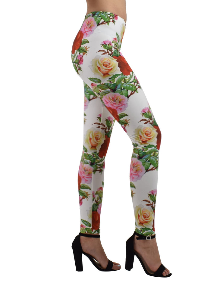 Side view of Denimaxx Rose Thorns leggings with red, pink, and yellow roses on white, modeled with black block heels.