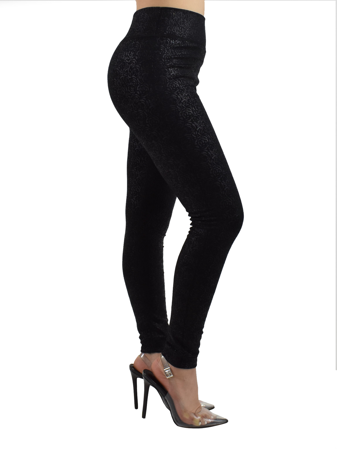 Side view of Denimaxx black lined leggings with subtle floral embossing, modeled with clear-strap heels.