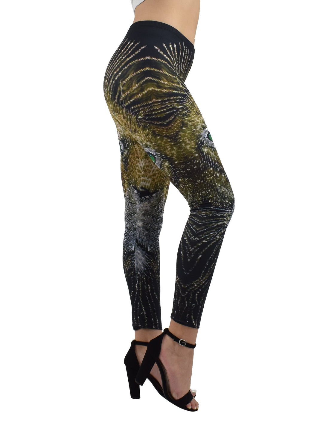 Side view of Denimaxx Light of the Lion print leggings with golden lion face and green eye detail, modeled with black heels.