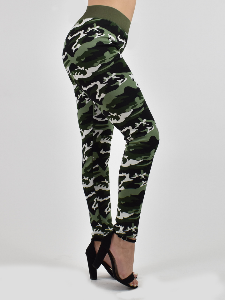Woman modeling Denimaxx lined camo leggings at a three-quarter angle, green camouflage print with black block heels.