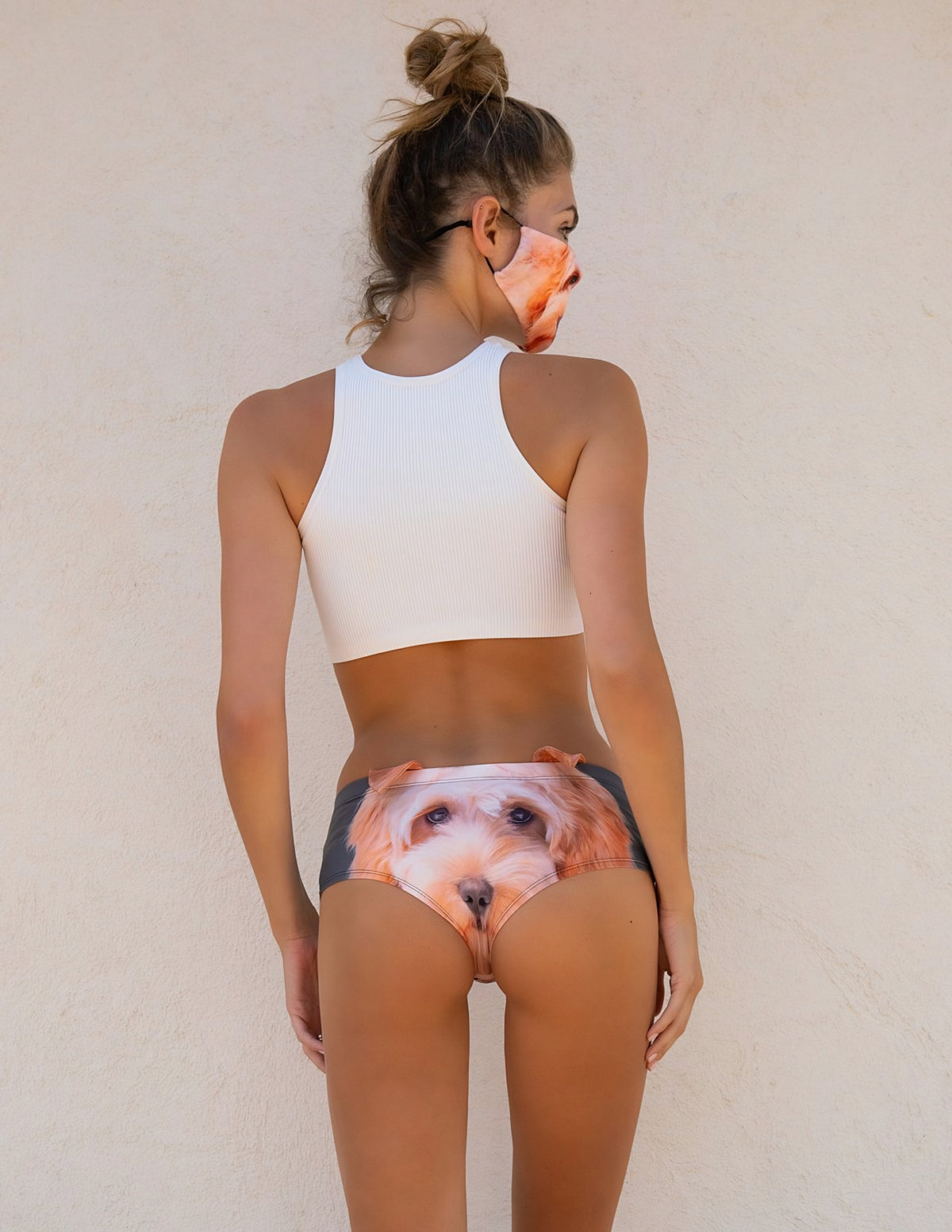 Back view of woman wearing Goldendoodle print panties with the apricot Goldendoodle face, white halter top, and dog print mask.