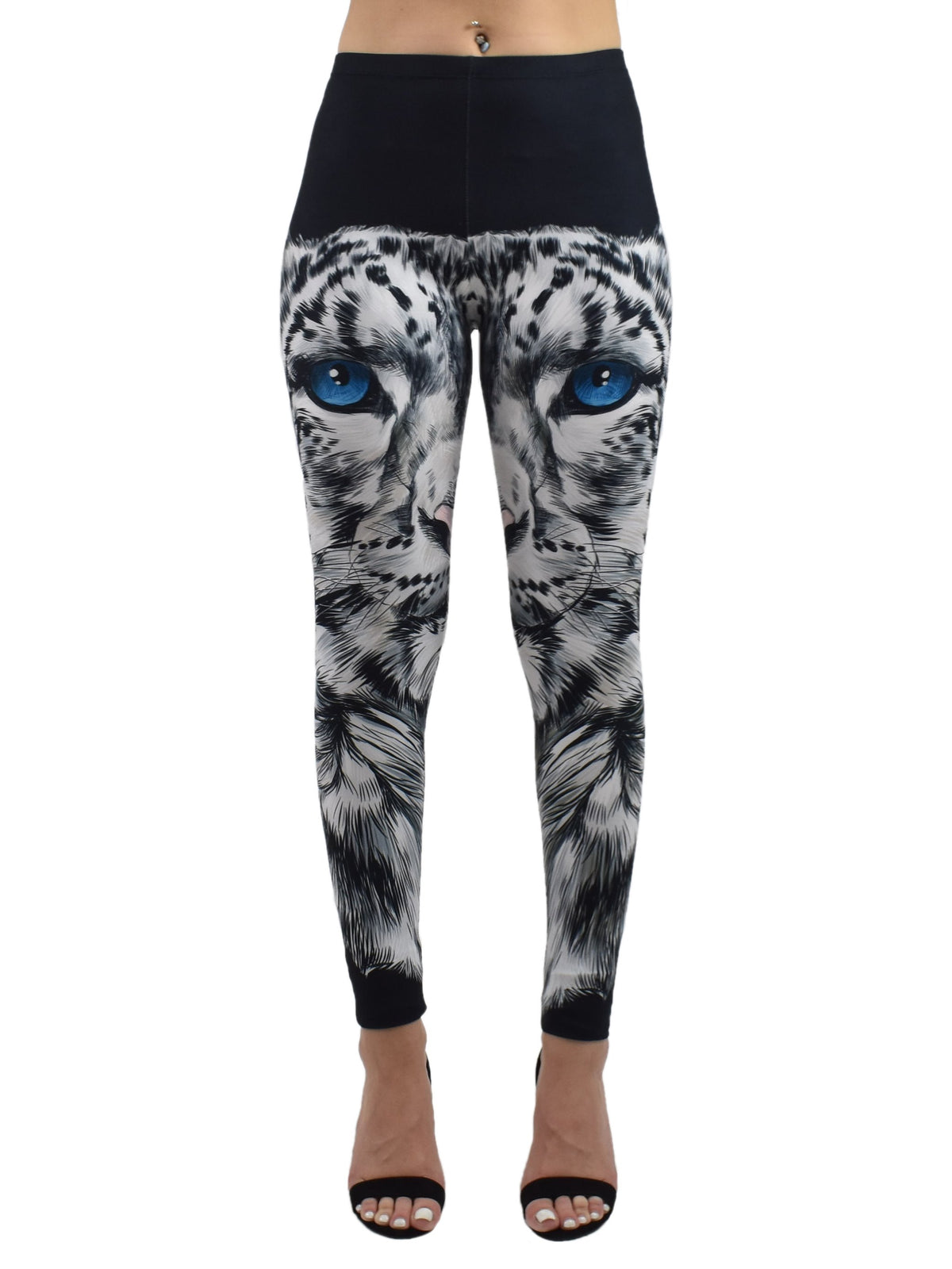 Front studio shot of snow leopard print leggings with blue-eyed snow leopard face on model in black heels, white background.