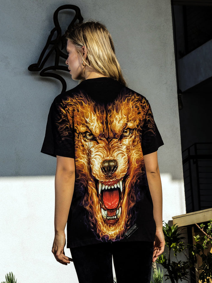 Back view of woman wearing the Denimaxx black Hell Hound beaded glow shirt showing the beaded snarling hound design on the back.